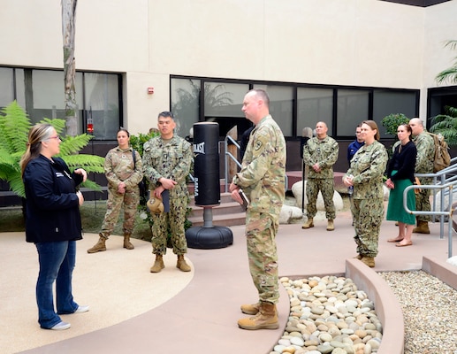 Tabitha Shannon, Naval Medical Center San Diego's Comprehensive Combat and Complex Casualty Care department's division officer, left, speaks to Uniformed Services University of Health Science Brigade leadership and team members in the rehabilitation courtyard during a tour of NMCSD, April 24, 2024. Navy Medicine Readiness and Training Command San Diego’s mission is to prepare service members to deploy in support of operational forces, deliver high quality healthcare services and shape the future of military medicine through education, training and research. NMRTC San Diego employs more than 6,000 active duty military personnel, civilians and contractors in Southern California to provide patients with world-class care anytime, anywhere. (U.S. Navy photo by Mass Communication Specialist 2nd Celia Martin)