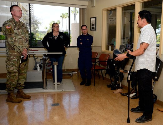 Nathaniel Leoncio, Naval Medical Center San Diego's Comprehensive Combat and Complex Casualty Care department's prosthetist, right, speaks to Uniformed Services University of Health Science Brigade leadership and team members in the prosthetics center during a visit and tour at NMCSD, April 24, 2024. Navy Medicine Readiness and Training Command San Diego’s mission is to prepare service members to deploy in support of operational forces, deliver high quality healthcare services and shape the future of military medicine through education, training and research. NMRTC San Diego employs more than 6,000 active duty military personnel, civilians and contractors in Southern California to provide patients with world-class care anytime, anywhere. (U.S. Navy photo by Mass Communication Specialist 2nd Celia Martin)