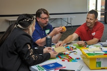 Jamie Anderson, Peter Dorando and Jeffrey Brewer, Strategic Weapons Facility, Atlantic employees, make a creation during the DoD FIRST Lego course at Naval Submarine Base Kings Bay, Ga., April 23-24. The program provides elementary, middle and high school teachers with kits and skills to assist with teaching children ages 4 to 18 about science, technology, engineering, and math (STEM) through engaging, hands-on learning.