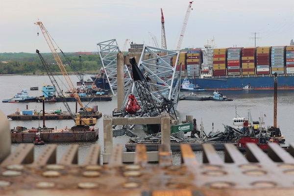 A large number of floating cranes can be seen at the site of the Francis Scott Key Bridge collapse. The MV Dali, the container ship which struck the bridge, is visible in the distance.