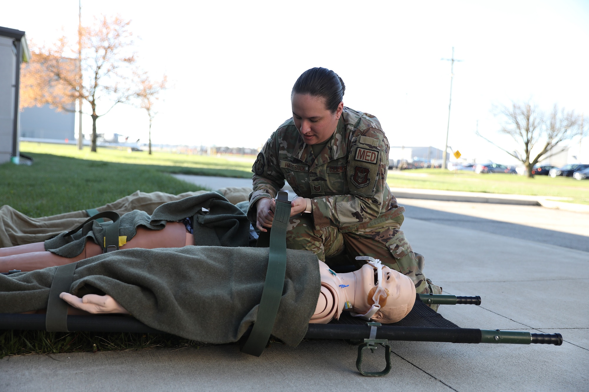 Tech. Sgt. Brittany Hartsock, 445th Aeromedical Staging Squadron aerospace medical technician, tightens a strap during launch and recovery training held at Wright-Patterson Air Force Base, Ohio, April 6, 2024.