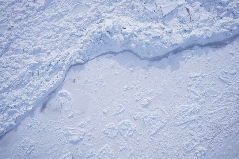 An image captured by drone during the Integrated Support for Operations in Polar Seas project fieldwork in Utqiagvik, Alaska, shows the variability of Arctic sea ice. The image shows a large pressure ridge, that was previously the lead edge, with freshly frozen thin ice next to it. The darker ice between the older and newer ice is the weakest point, indicating where the ice would potentially break with wind or current movement.