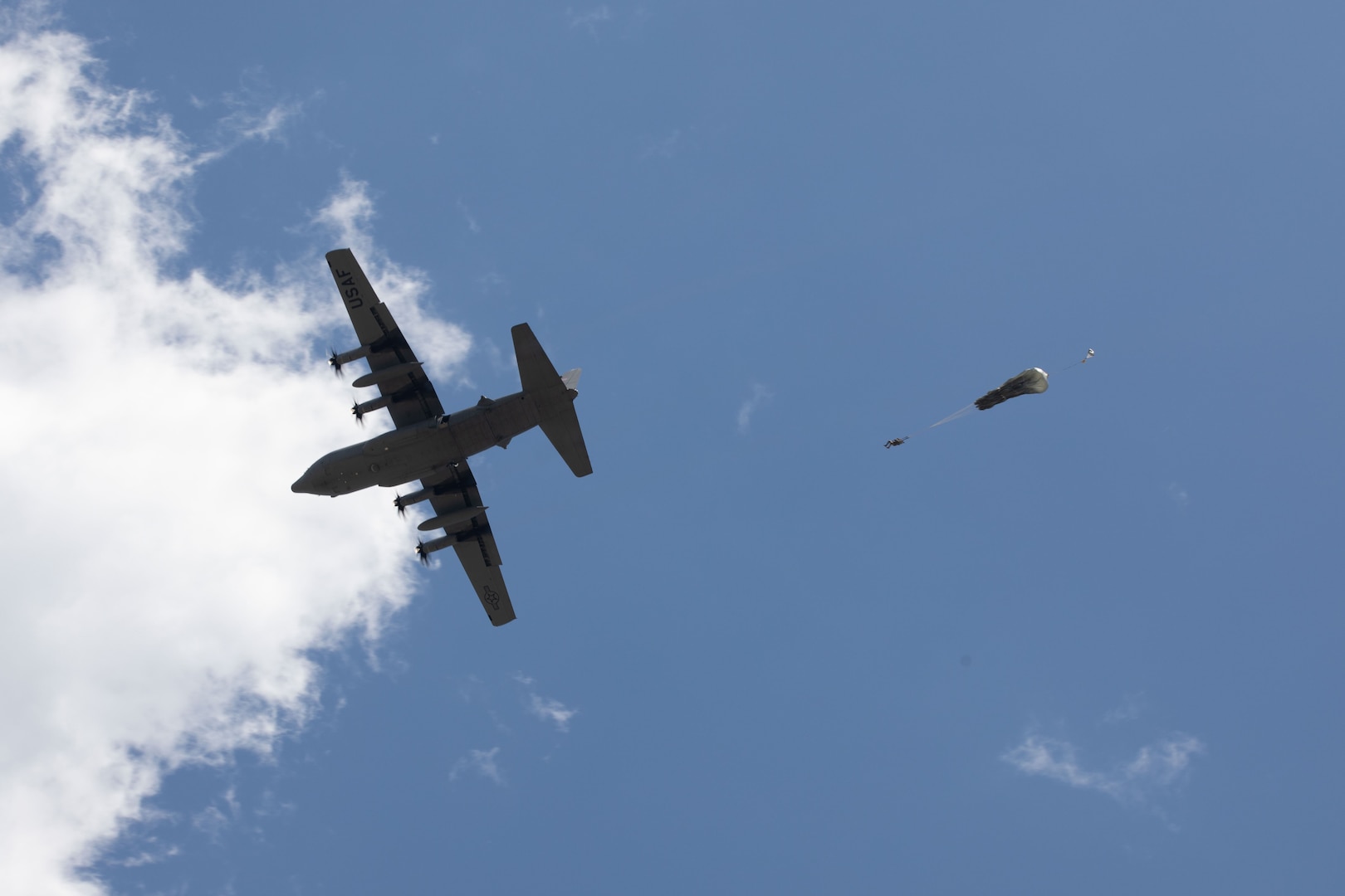 A U.S. Army Soldier conducts a static line airborne jump out of a C-130 Hercules cargo plane during the Joint Parachute Operational Mishap Preventative Orientation Course Enhanced (POMPOC-E) April 25, 2024, at the Plantation Airpark, Sylvania, Georgia.