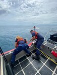 A Coast Guad Station San Juan 33-Special Purpose Craft boat crew rescued three fishermen from the hull of the 22-foot recreational vessel Elaine, April 27, 2024, after a large wave caused the vessel to capsize, approximately two nautical miles north of Dorado, Puerto Rico.  All three boaters were wearing their lifejackets and there were not injuries or medical emergencies.  (U.S. Coast Guard photo)