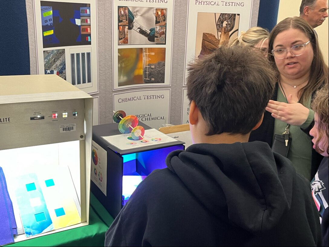 Defense Logistics Agency Troop Support chemist Jessica Posio explains the process of shade testing at Take Our Daughters and Sons to Work Day event on April 25 in Philadelphia.