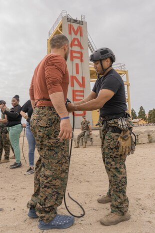 U.S. Marine Corps Gunnery Sgt. Jeff Ibanezdiaz, a helicopter rope suspension technique master with Support Battalion, Recruit Training Regiment, assists educators from Recruiting Stations Chicago, Kansas City and Saint Louis seat their rappel harnesses as part of the 2024 Educator’s Workshop at Marine Corps Recruit Depot San Diego, California, April 25, 2024. Participants of the workshop visit MCRD San Diego to observe recruit training and gain a better understanding about the transformation from recruits to United States Marines. Educators also received classes and briefs on the benefits that are provided to service members serving in the United States armed forces. (U.S. Marine Corps photo by Lance Cpl. Alexandra M. Earl)