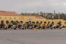 U.S. Marines with Golf Company, 2nd Recruit Training Battalion, execute dynamic warm-ups prior to a motivational run at Marine Corps Recruit Depot San Diego, California, April 25, 2024. The motivational run is the final training event new Marines complete before graduating which consists of a three-mile run throughout the Depot. (U.S. Marine Corps photo by Lance Cpl. Alexandra M. Earl)