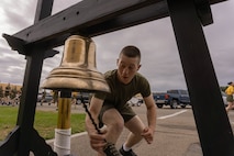New U.S. Marines with Golf Company, 2nd Recruit Training Battalion, ring the liberty bell during a motivational run at Marine Corps Recruit Depot San Diego, California, April 25, 2024. The motivational run is the final training event new Marines complete before graduating which consists of a three-mile run throughout the Depot. (U.S. Marine Corps photo by Lance Cpl. Alexandra M. Earl)