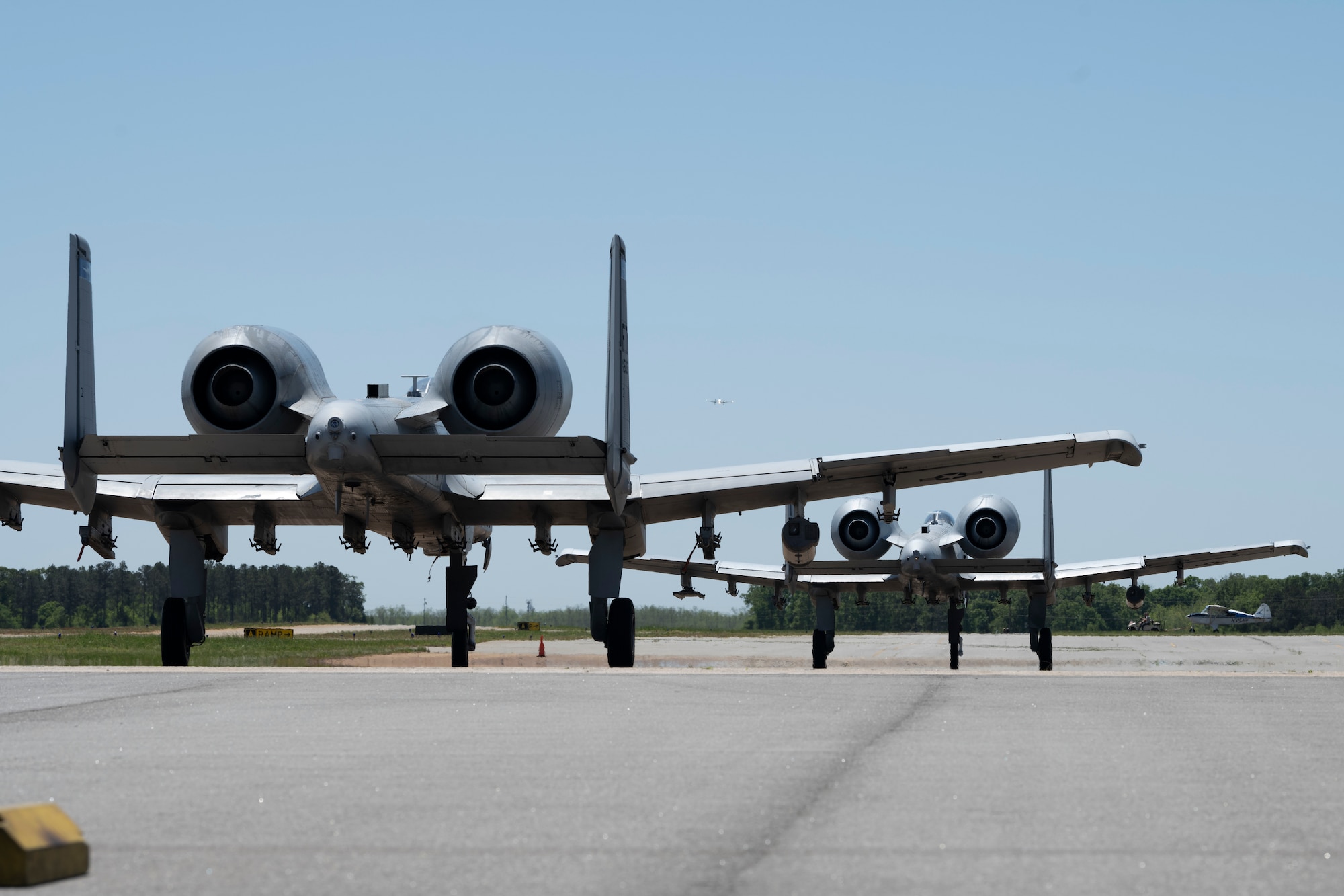 Two A-10C Thunderbolt II Aircraft sitting on a flightline.