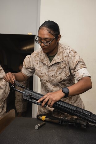 U.S. Marine Corps Recruit Michelle Ayala with Lima Company, 3rd Recruit Training Battalion, reassembles a M16-A4 service rifle during a practical application exam at Marine Corps Recruit Depot San Diego, California, April 24, 2024. The recruits learned how to apply aid to a variety of injuries and how to assemble and disassemble their rifles. Recruits have several opportunities to practice before exam one and the practical application test. (U.S. Marine Corps photo by Lance Cpl. Janell B. Alvarez)