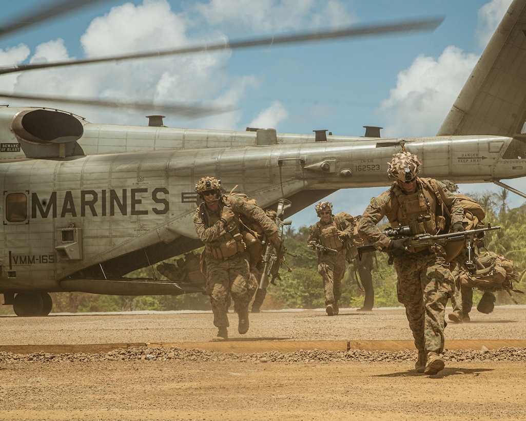 U.S. Marines assigned to Alpha Company, Battalion Landing Team 1/5, 15th Marine Expeditionary Unit, offload a CH-53E Super Stallion attached to Marine Medium Tiltrotor Squadron (VMM) 165 (Reinforced), 15th MEU, during a key terrain security mission as part of Exercise Balikatan 24 on Balabac Island, Philippines, April 26, 2024. BK 24 is an annual exercise between the Armed Forces of the Philippines and the U.S. military designed to strengthen bilateral interoperability, capabilities, trust, and cooperation built over decades of shared experiences. (U.S. Marine Corps photo by Lance Cpl. Peyton Kahle)