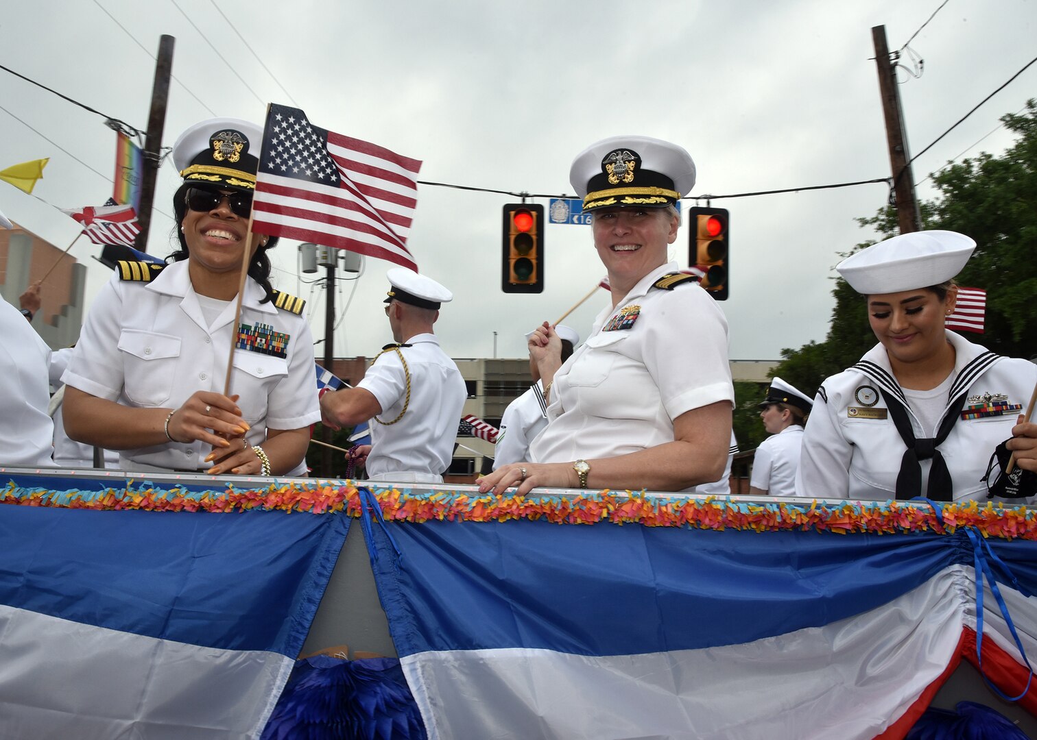 SAN ANTONIO - (April 26, 2024) –   Capt. Jennifer Buechel (Nurse Corps), commanding officer, Naval Medical Research Unit (NAMRU) San Antonio (right), and Cmdr. Nneoma Lewis (Nurse Corps), non-medical medical case manager, Navy Wounded Warrior (NWW) Program, Navy Region Southeast, participated in the Battle of Flowers Parade held during Fiesta San Antonio. The Battle of Flowers Parade is the oldest event and largest parade of Fiesta San Antonio attracting crowds of more than 350,000. Leading the Sailors in the parade was Rear Adm. Walter Brafford, commander, Naval Medical Forces Support Command (NMFSC). Joint Base San Antonio is proud to be part of the diverse and vibrant community of San Antonio also known as Military City USA. (U.S. Navy Photo by Burrell Parmer, Naval Medical Research Unit San Antonio Public Affairs/Released)