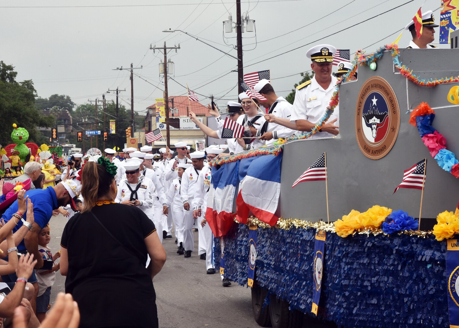SAN ANTONIO - (April 26, 2024) – More than 100 Sailors within Joint Base San Antonio (JBSA) took part in the Battle of Flowers Parade held during Fiesta San Antonio. The Battle of Flowers Parade is the oldest event and largest parade of Fiesta San Antonio attracting crowds of more than 350,000. Leading the Sailors in the parade was Rear Adm. Walter Brafford, commander, Naval Medical Forces Support Command (NMFSC). Other commands participating included but not limited to Naval Medical Research Unit (NAMRU) San Antonio, Navy Talent Acquisition Group (NTAG) San Antonio, Navy Medicine Training Support Center (NMTSC), and Navy Wounded Warrior (NWW) Program, Navy Reserve Center (NRC) San Antonio, and USS San Antonio (LPD 17). Joint Base San Antonio is proud to be part of the diverse and vibrant community of San Antonio also known as Military City USA. (U.S. Navy Photo by Burrell Parmer, Naval Medical Research Unit San Antonio Public Affairs/Released)