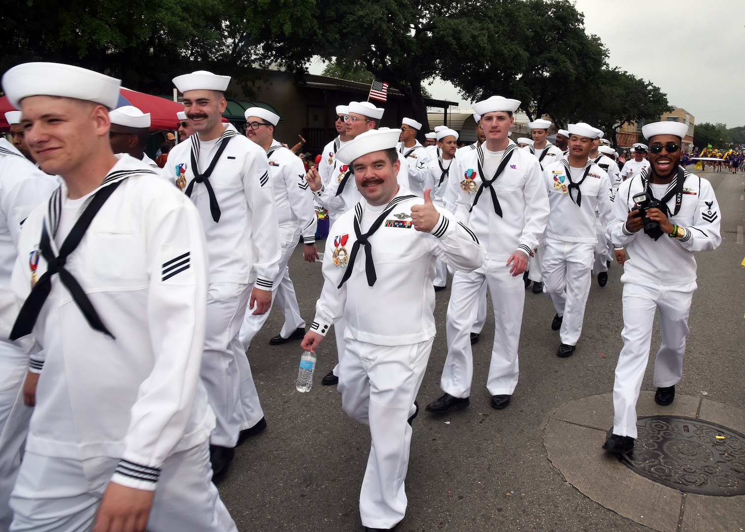 SAN ANTONIO - (April 26, 2024) – More than 100 Sailors within Joint Base San Antonio (JBSA) took part in the Battle of Flowers Parade held during Fiesta San Antonio. The Battle of Flowers Parade is the oldest event and largest parade of Fiesta San Antonio attracting crowds of more than 350,000. Leading the Sailors in the parade was Rear Adm. Walter Brafford, commander, Naval Medical Forces Support Command (NMFSC). Other commands participating included but not limited to Naval Medical Research Unit (NAMRU) San Antonio, Navy Talent Acquisition Group (NTAG) San Antonio, Navy Medicine Training Support Center (NMTSC), and Navy Wounded Warrior (NWW) Program, Navy Reserve Center (NRC) San Antonio, and USS San Antonio (LPD 17). Joint Base San Antonio is proud to be part of the diverse and vibrant community of San Antonio also known as Military City USA. (U.S. Navy Photo by Burrell Parmer, Naval Medical Research Unit San Antonio Public Affairs/Released)