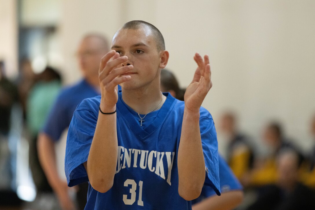 A Bluegrass ChalleNGe Academy cadet claps as his team scores during at volleyball match on Friday, March 26 at the Tri-State Challenge.