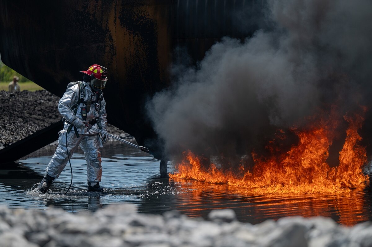 Ai Force firefighter starts the flame for Airmen to participate in an exercise