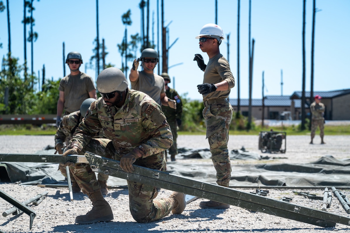 Coalition Team members get together to help build a structure