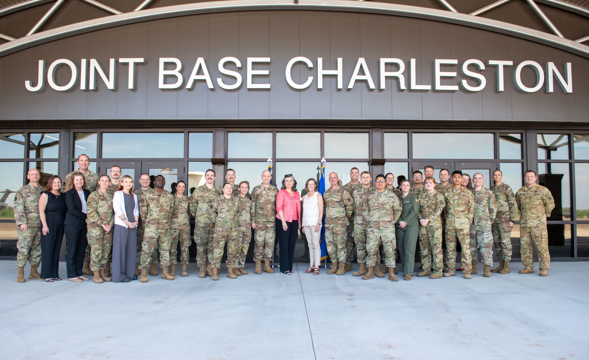 U.S. Air Force Chief of Staff Gen. David Allvin, center left, and Chief Master Sgt. of the Air Force David Flosi, center right, pose for a group photo with their spouses and Joint Base Charleston Airmen at Joint Base Charleston, South Carolina, April 26, 2024. Allvin and Flosi met with Airmen, recognized outstanding performers, and hosted an all call to discuss the need for rapid reoptimization of forces to effectively confront great power competition. (U.S. Air Force photo by Senior Airman Christian Silvera)