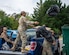 Airmen assigned to the 316th Civil Engineer Squadron throw away trash bags after the base wide cleanup.