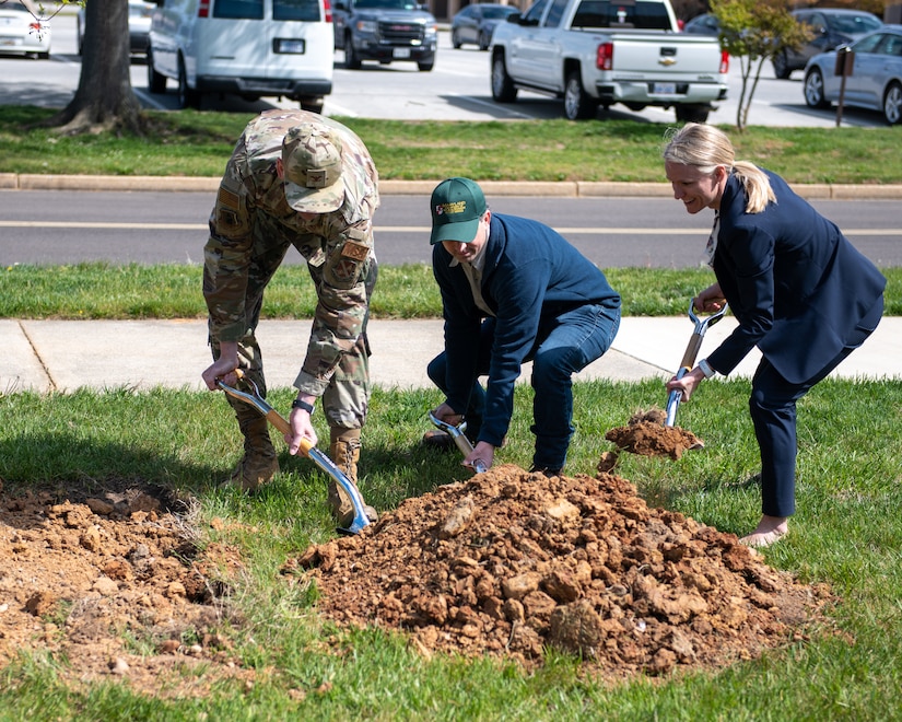 From left, U.S. Air Force Col. Nate Somers, 316th Mission Support Group commander, Dan Coy, Maryland Department of Natural Resources Urban and Community Forestry supervisor, and Stephanie Frizzo, 316th Civil Engineering Squadron deputy director plant a pin oak tree.