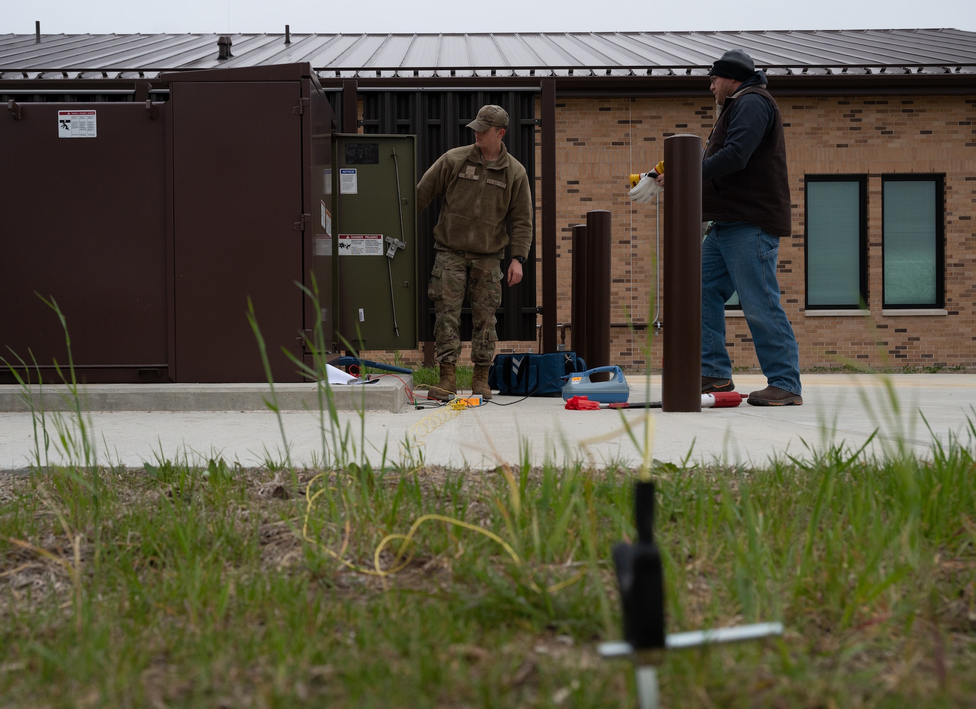 U.S. Airman and civilian assigned to the 509th Civil Engineering Squadron prepare to conduct a site survey at Whiteman Air Force Base, Mo. March 26, 2024. CE has gone from contracting out locates of underground electric lines to doing locates in house, reducing dig permit cost from $3,236 to $160. (U.S. Air Force photo by Senior Airman Joseph Garcia)