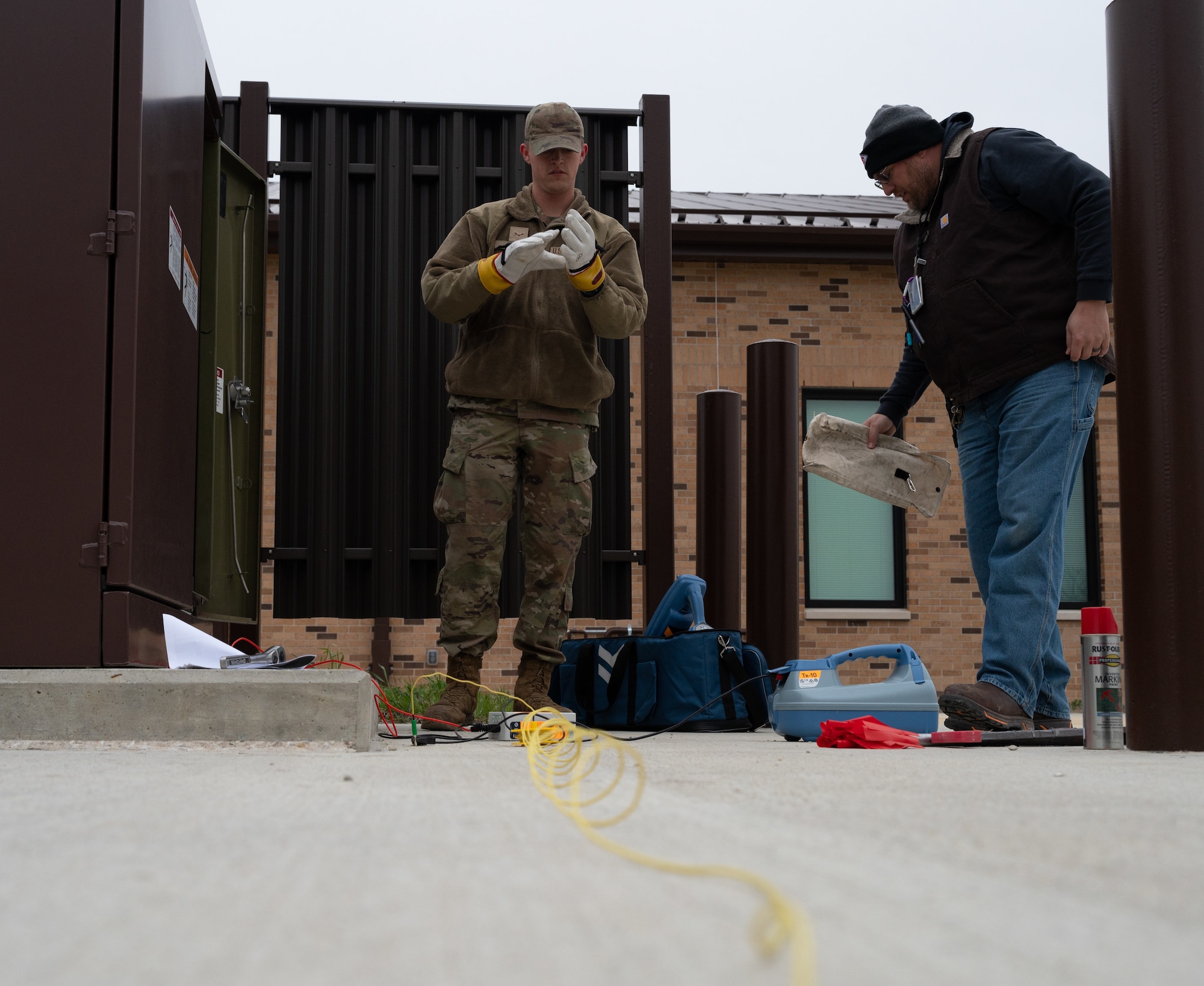 U.S. Airman and civilian assigned to the 509th Civil Engineering Squadron prepare to conduct a site survey at Whiteman Air Force Base, Mo. March 26, 2024. CE has gone from contracting out locates of underground electric lines to doing locates in house, reducing dig permit cost from $3,236 to $160. (U.S. Air Force photo by Senior Airman Joseph Garcia)