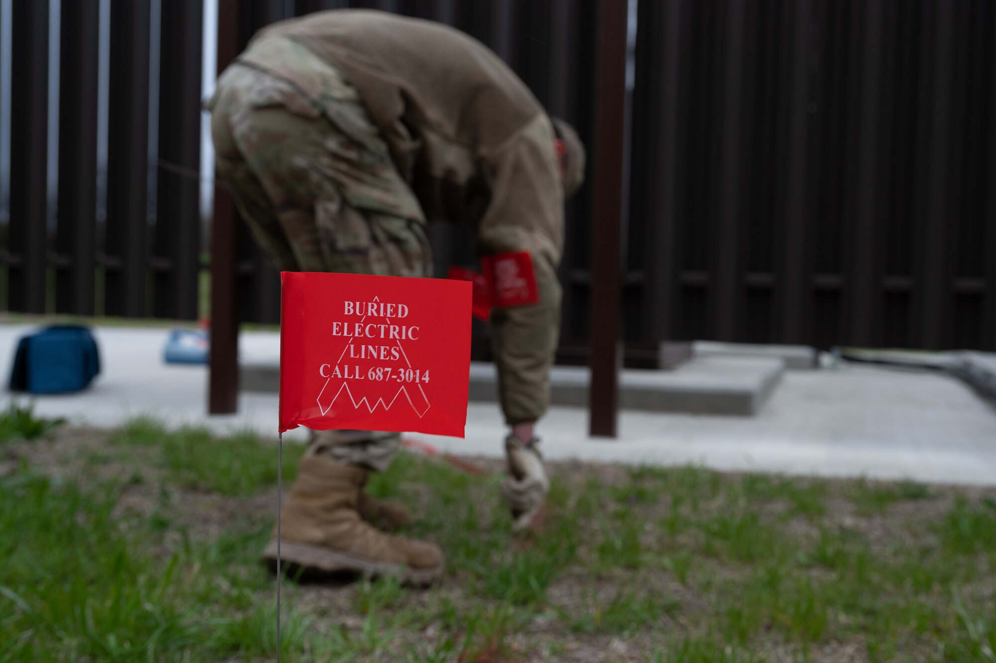 U.S. Air Force A1C Ethan Welsh, 509th Civil Engineering Electric, electrical systems apprentice marks an underground cable with flags at Whiteman Air Force Base, Mo., March 26, 2024. CE Airmen are using Radiodetection RD7200 locators to survey underground cables rather than contracting surveys, reducing dig permit cost from $3,236 to $160. (U.S. Air Force photo by Senior Airman Joseph Garcia)