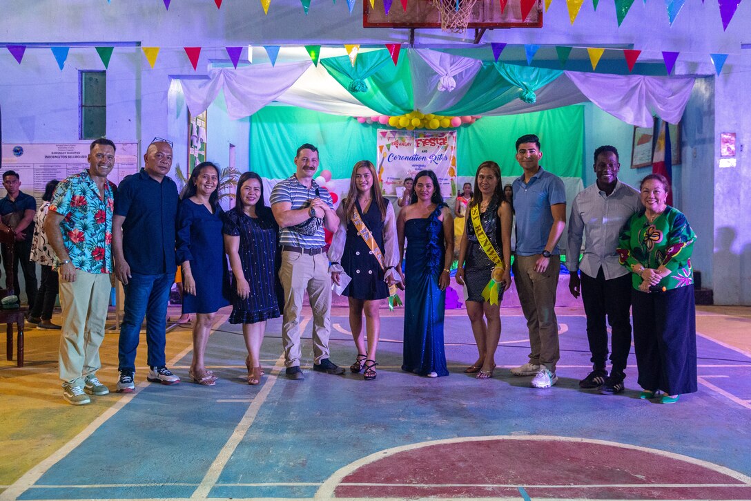 U.S. Marines with Marine Wing Support Squadron 174, Marine Aircraft Group 24, 1st Marine Aircraft Wing and 1st Civil Affairs Group, pose for a photograph with local government officials and Lal-lo residents as part of a ‘Barangay Fiesta’ during Exercise Balikatan 24 at Dagupan Barangay Hall, Lal-lo, Cagayan, Philippines, April 24, 2024. BK 24 is an annual exercise between the Armed Forces of the Philippines and the U.S. military designed to strengthen bilateral interoperability, capabilities, trust and cooperation built over decades of shared experiences. (U.S. Marine Corps photo by Cpl. Trent A. Henry)