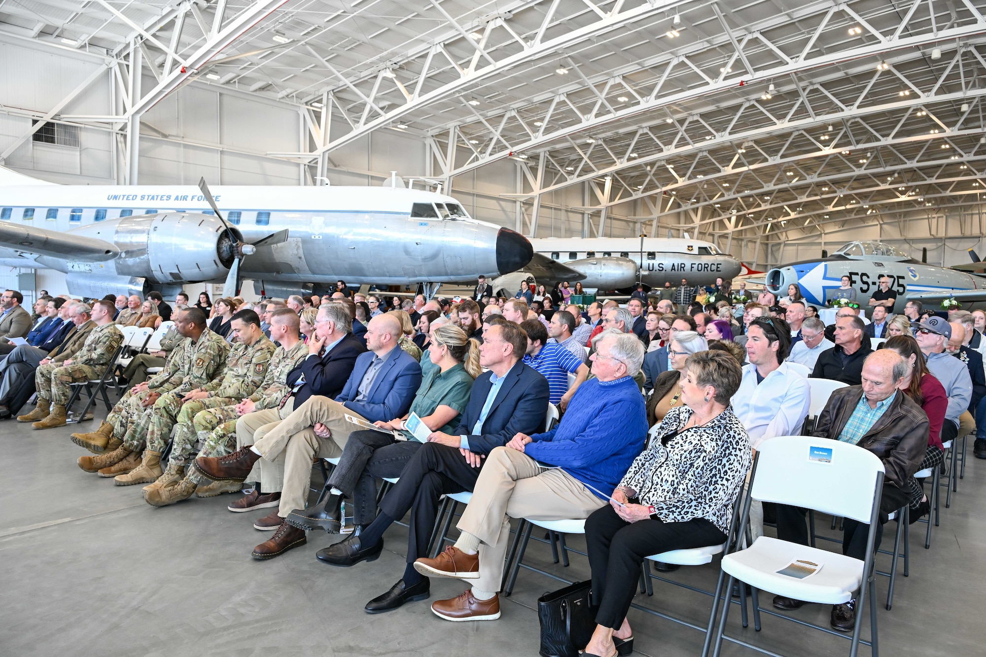 Guests listen to speakers during the ribbon cutting ceremony of the new L.S. Skaggs Gallery at the Hill Aerospace Museum at Hill Air Force Base, Utah, April 29, 2024. The new gallery is a 91,000 square foot hangar and provides a 70% increase to the indoor exhibition space. (U.S. Air Force photo by Cynthia Griggs)
