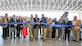 (Center) Col. Jeffrey Holland, 75th Air Base Wing commander, Robb Alexander, executive director of the Aerospace Heritage Foundation of Utah, and Aaron Clark, Hill Aerospace Museum director, cut the ribbon during a ceremony commemorating the opening of the new L.S. Skaggs Gallery at the Hill Aerospace Museum at Hill Air Force Base, Utah, April 29, 2024. The new gallery is a 91,000 square foot hangar and provides a 70% increase to the indoor exhibition space. (U.S. Air Force photo by Cynthia Griggs)