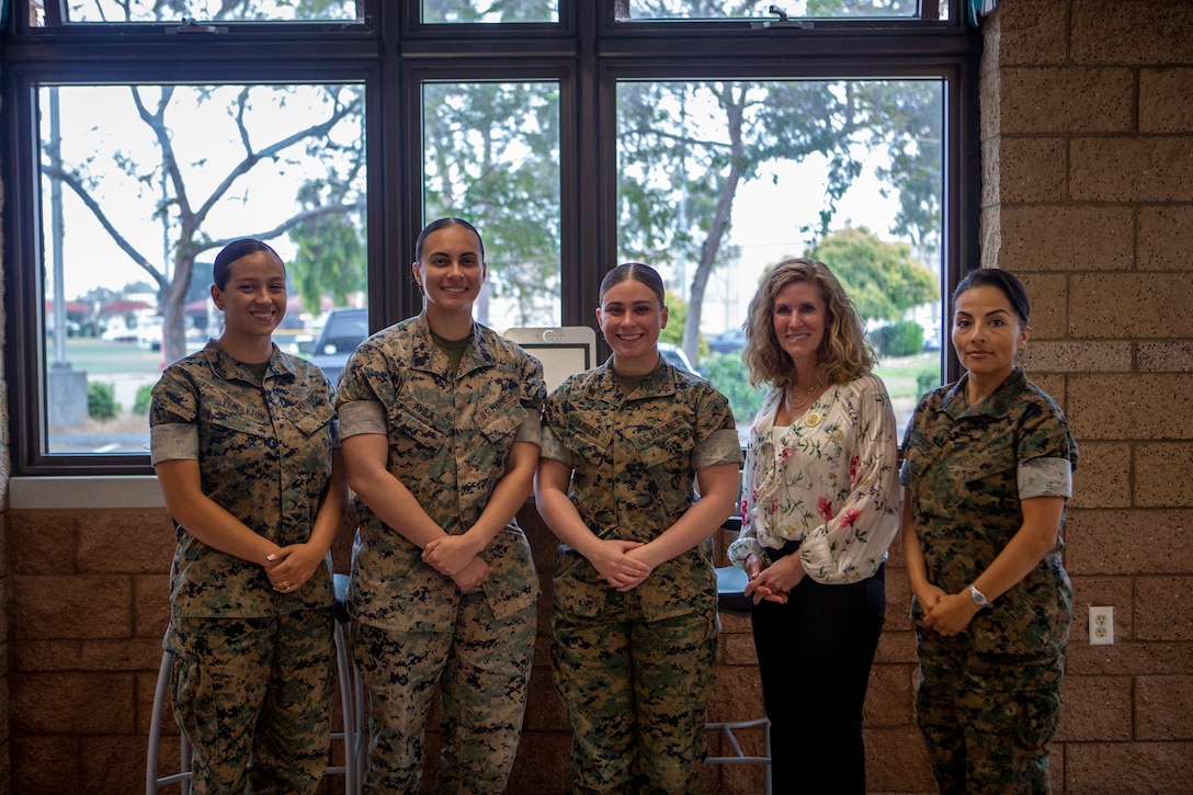 U.S. Marines stationed on Marine Corps Air Station Miramar pose for a group photo with a representative from the Defense Advisory Committee on Women in the Services after a luncheon on MCAS Miramar, California, April 22, 2024. The purpose of the luncheon was to conduct research on behalf of Lloyd J. Austin III, the Secretary of Defense, in an informal setting. (U.S. Marine Corps photo by Pfc. Seferino Gamez)