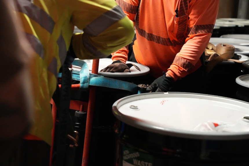 HALAWA, Hawaii (April 23, 2024) Navy Closure Task Force-Red Hill (NCTF-RH) contractors strap a barrel of aqueous film-forming foam (AFFF) concentrate to a hand cart to remove it from the Red Hill Bulk Fuel Storage Facility (RHBFSF) in Halawa, Hawaii, April 23, 2024. NCTF-RH removed thirty-two 55-gallon barrels, which will be transported off island for disposal. Charged with the safe decommissioning of the RHBFSF, NCTF-RH was established by the Department of the Navy as a commitment to the community and the environment. The Navy continues to engage with the people of Hawaii, regulatory agencies, and other stakeholders as NCTF-RH works to safely and deliberately decommission the RHBFSF. (U.S. Navy photo by Mass Communication Specialist 1st Class Glenn Slaughter)