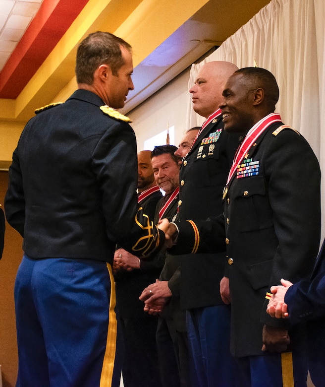 Albuquerque District Commander Lt. Col. Jerre Hansbrough, left, presents the Bronze de Fleury Medal to Capt. Romeo Tcheutchua, project engineer at the district's Cannon Resident Office, during the Albuquerque District Ball, Feb. 17, 2024, in Albuquerque, N.M.