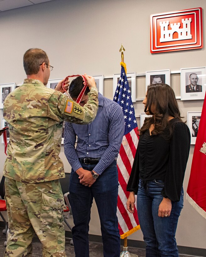 Albuquerque District Commander Lt. Col. Jerre Hansbrough presents the Steel de Fleury Medal to Samuel Tafoya, civil engineer in the district's General Engineering Section, during a district town hall meeting at the district’s Albuquerque office, March 12, 2024.