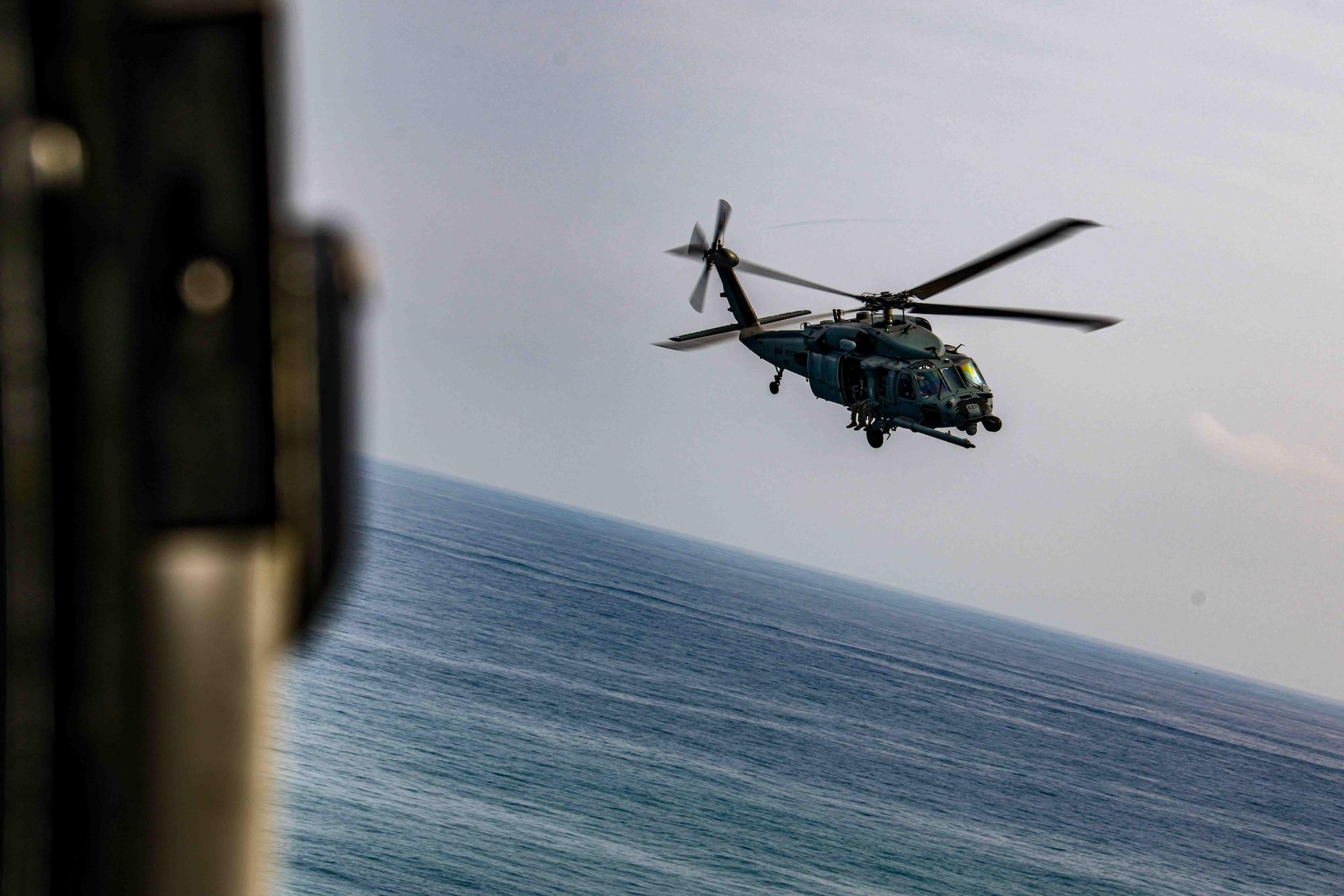 A U.S. Air Force HH-60G Pave Hawk assigned to the 33rd Rescue Squadron flies in formation off the coast of Okinawa, April 16, 2024.