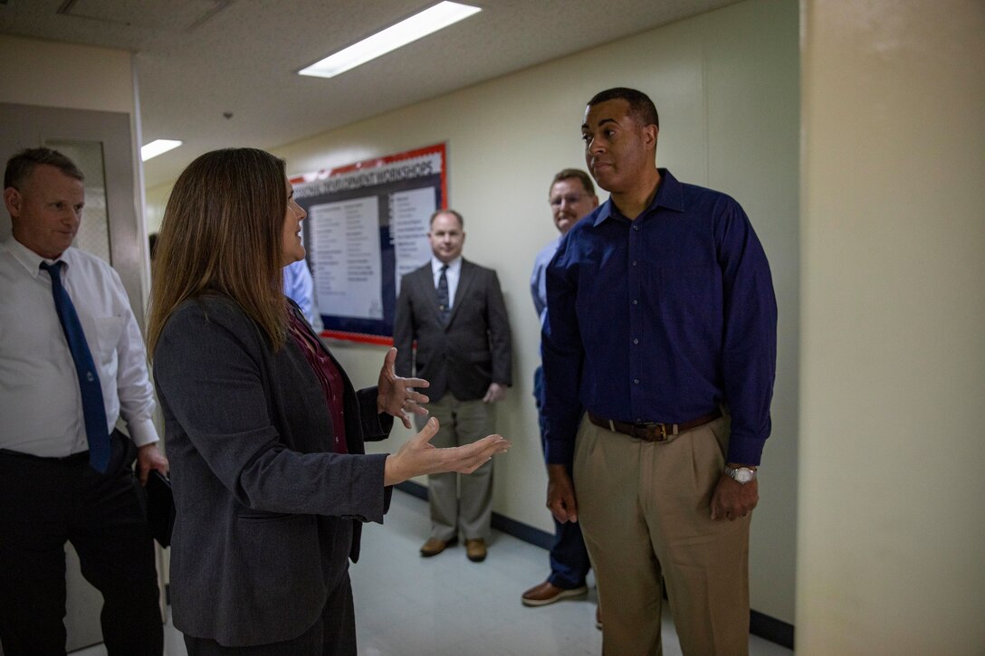 Dr. Rachel Forbes, center left, an education and career program manager with Marine Corps Community Services Iwakuni, and a native of New York, gives a tour to Franklin Parker, right, assistant secretary of the Navy for manpower and reserve affairs, and a native of California, at Marine Corps Air Station Iwakuni Japan, April 18, 2024. Parker visited MCAS Iwakuni to better understand the air station’s unique manpower structure and to learn how the base and tenant units work alongside their Japanese counterparts to support the installation’s diverse operations. (U.S. Marine Corps photo by Lance Cpl. David Getz)