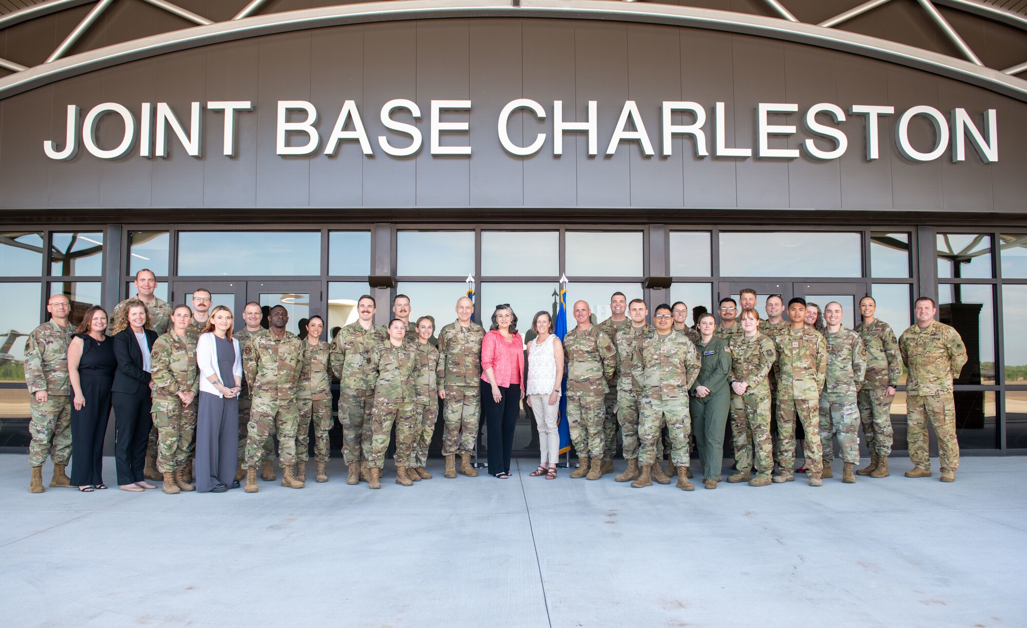 U.S. Air Force Chief of Staff Gen. David Allvin, center left, and Chief Master Sgt. of the Air Force David Flosi, center right, pose for a group photo with their spouses and Joint Base Charleston Airmen at Joint Base Charleston, South Carolina, April 26, 2024. Allvin and Flosi met with Airmen, recognized outstanding performers, and hosted an all call to discuss the need for rapid reoptimization of forces to effectively confront great power competition. (U.S. Air Force photo by Senior Airman Christian Silvera)