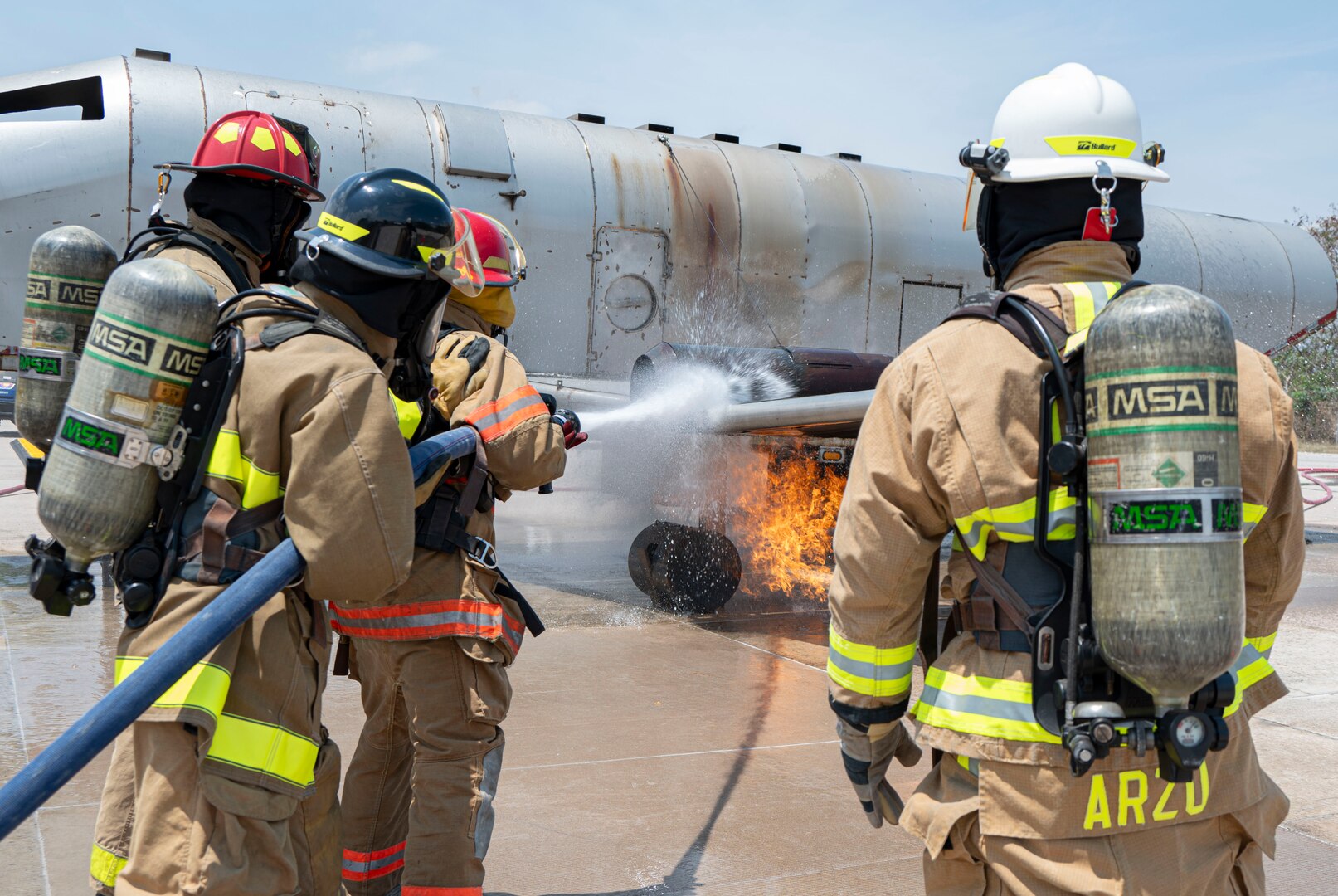 A photo of firefighters putting out a fire.