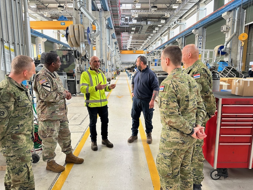 Marco Gragnani, a supervisory maintenance operations specialist and an Italian local national employee with Army Field Support Battalion-Africa (third from left), provides a few soldier maintainers from the Croatian army a tour of one of AFSBn-Africa’s maintenance facilities at Leghorn Army Depot in Livorno, Italy. Soldier maintainers from Croatian army were at Leghorn April 16-20 as part of a bilateral military-to-military APS-2 maintenance exchange with AFSBn-Africa. (Photo by Maj. Duane Dumlao, AFSBn-Africa executive officer)