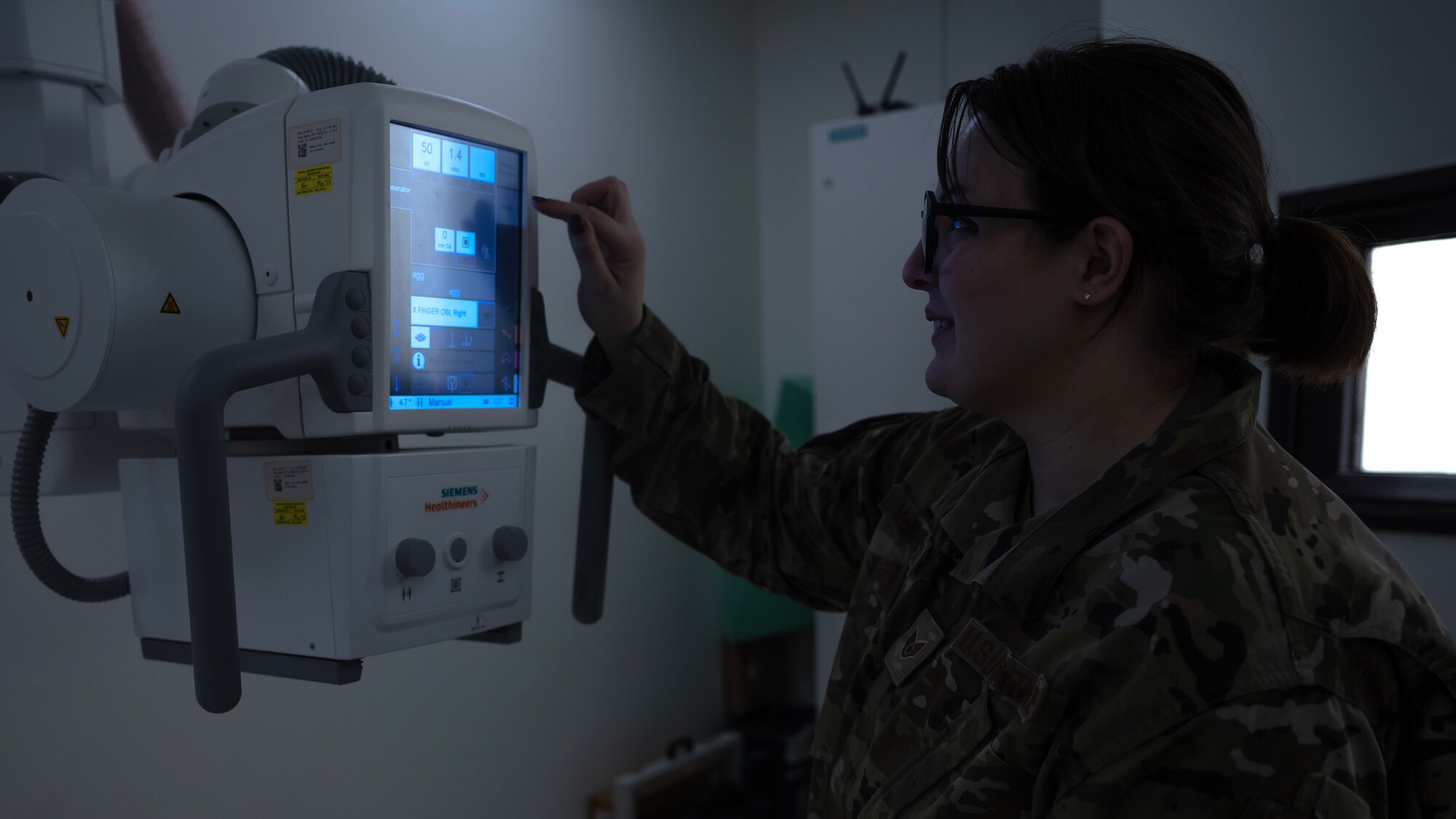 Photo of a female looking at a screen.