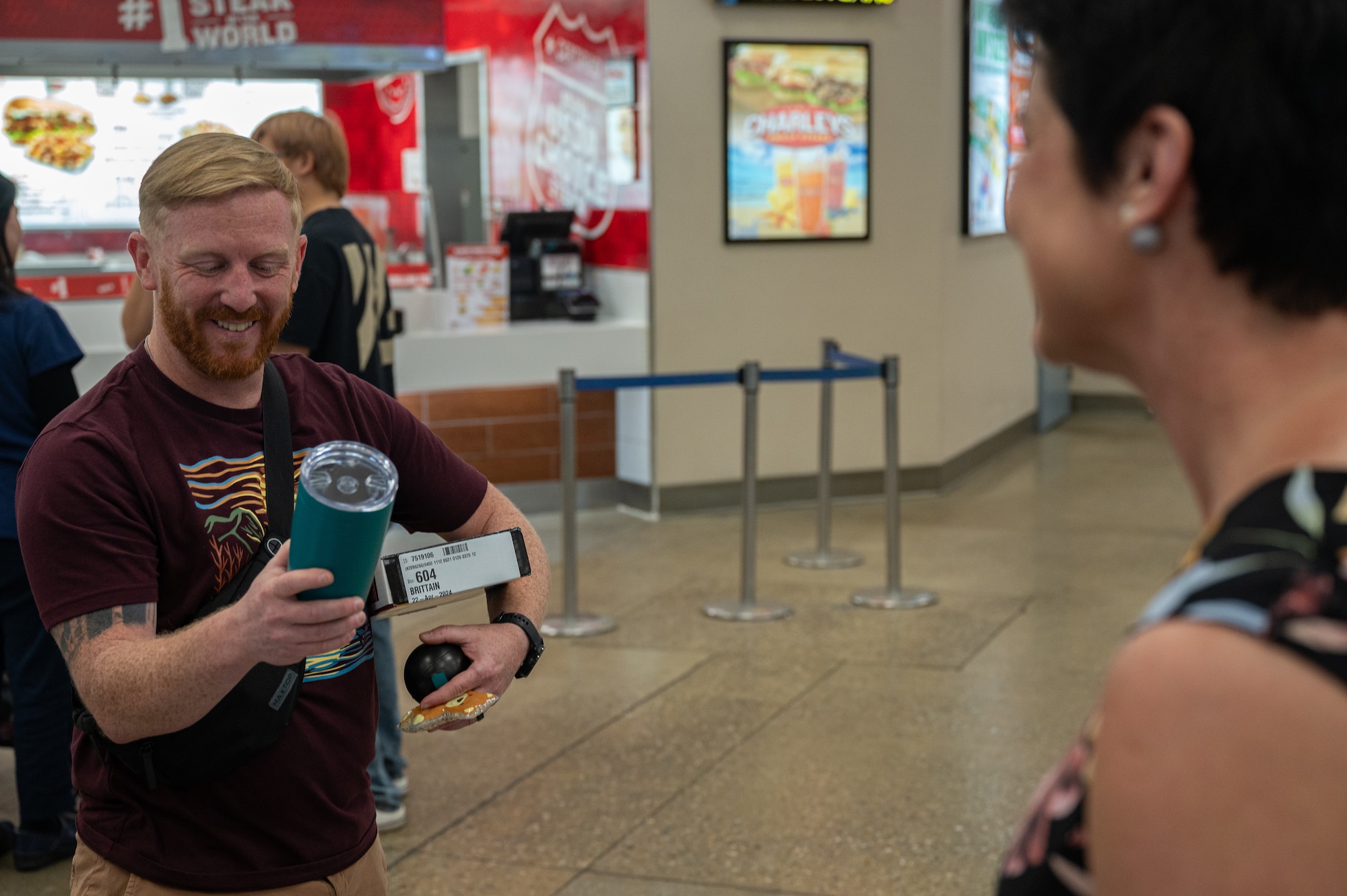 U.S. Air Force Tech. Sgt. David Brittain, 51st Fighter Wing information security specialist, left, receives a prize during a Sexual Assault Awareness and Prevention Month outreach event at Osan Air Base, Republic of Korea, April 22, 2024. Since 2004, Sexual Assault Prevention and Response has been a Department of Defense program that has the main focus of eliminating sexual assault, bolstering prevention efforts, increasing reporting and promoting advocacy for a safer community. (U.S. Air Force photo by Airman 1st Class Chase Verzaal)