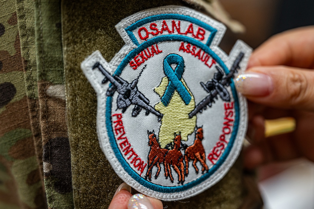 U.S. Air Force Capt. Favian Chung, 51st Fighter Wing director of protocol, receives a wing approved Osan Air Base Sexual Assault, Prevention and Response patch during Sexual Assault Awareness and Prevention Month at Osan AB, Republic of Korea, April 25, 2024. The 51st FW supports SAAPM by facilitating conversation and hosting events to raise awareness, including intervention and response training and reflection events like “What Were You Wearing?”. (U.S. Air Force photo by Airman 1st Class Chase Verzaal)