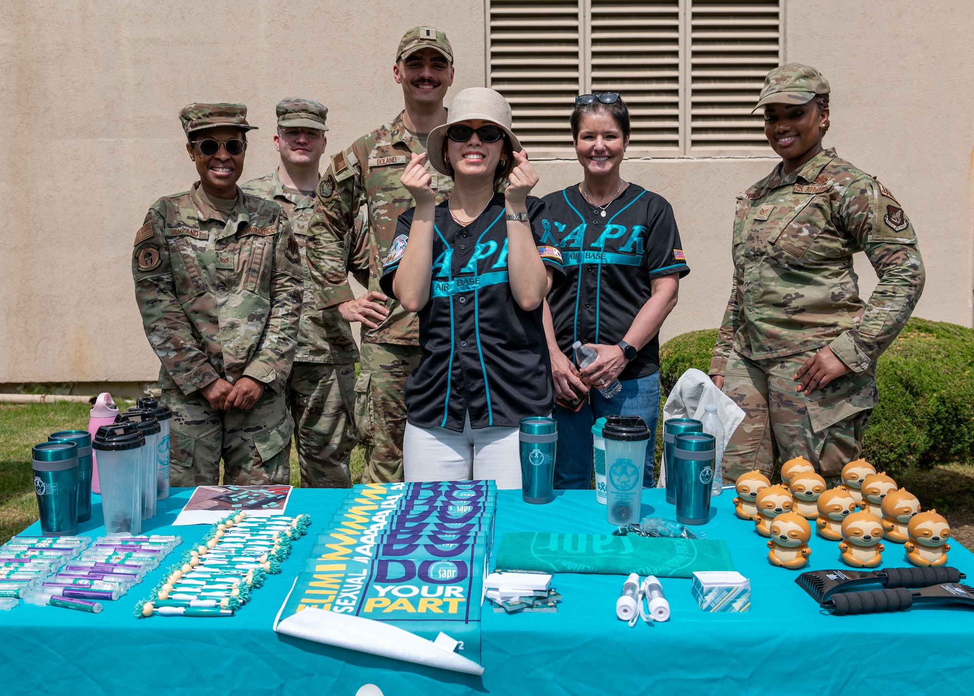Members of the 51st Fighter Wing Sexual Assault Prevention and Response office take a group photo during a Sexual Assault Awareness and Prevention Month open house event at Osan Air Base, Republic of Korea, April 19, 2024. Osan AB supports the SAAPM campaign by facilitating conversation and hosting events to spread awareness of the resources available to members at Osan AB. (U.S. Air Force photo by Staff Sgt. Aubree Owens)