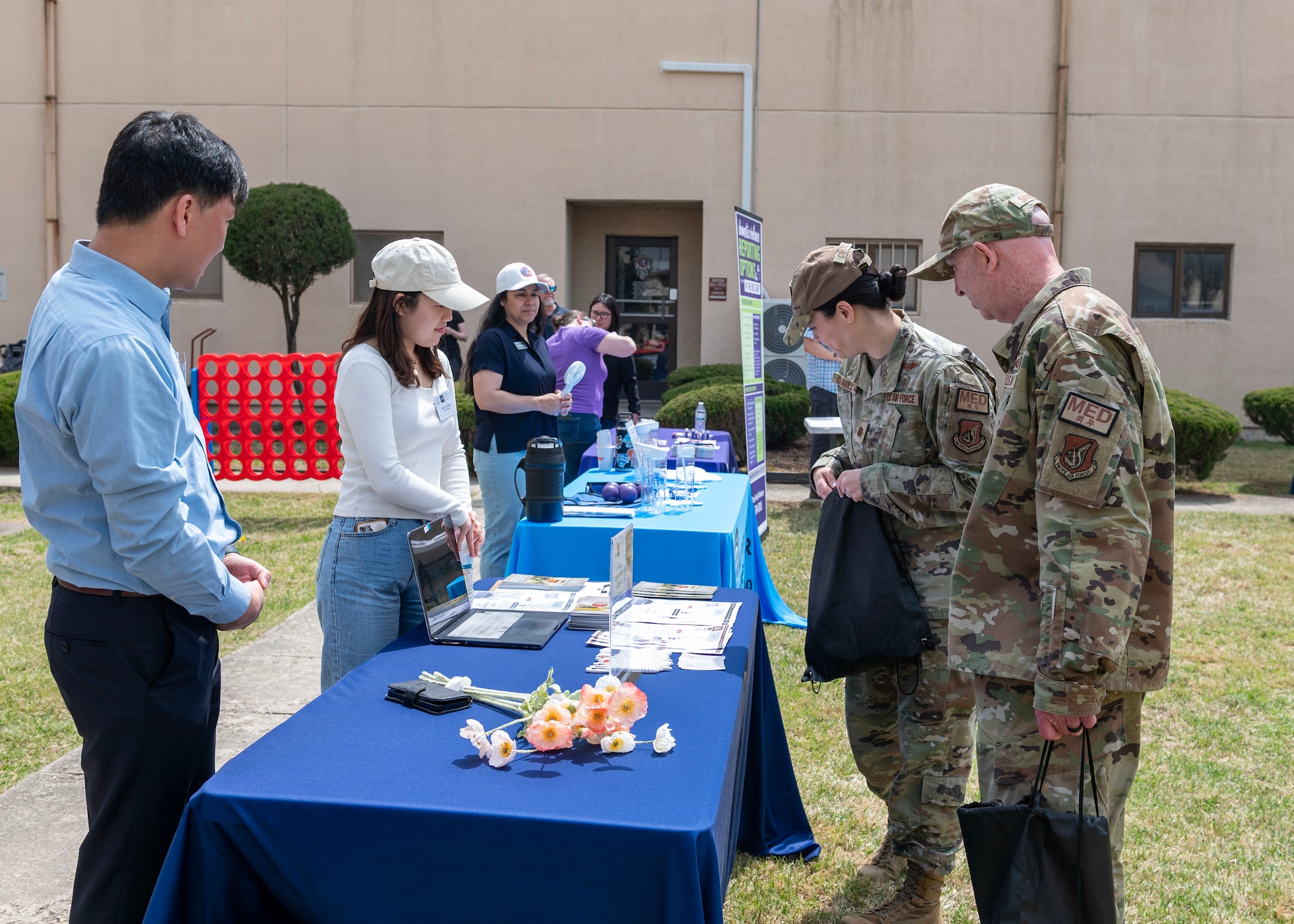 U.S. Air Force Airmen assigned to Osan Air Base, Republic of Korea, visit resource booths during a Sexual Assault Awareness and Prevention Month open house event at Osan Air Base, ROK, April 19, 2024. The 51st Fighter Wing Sexual Assault Prevention Response office has policies and programs that are designed to empower Airmen to foster a culture of dignity, mutual respect and trust. (U.S. Air Force photo by Staff Sgt. Aubree Owens)