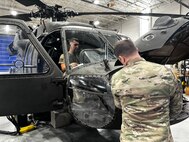 Virginia National Guard Soldiers conduct maintenance on a UH-60 Black Hawk helicopter April 2, 2024, at the Army Aviation Support Facility in Sandston, Virginia. The Soldiers are part of the AASF’s avionics shop, which troubleshoots, diagnoses and repairs avionic components and wiring on the VNG’s Black Hawk fleet.