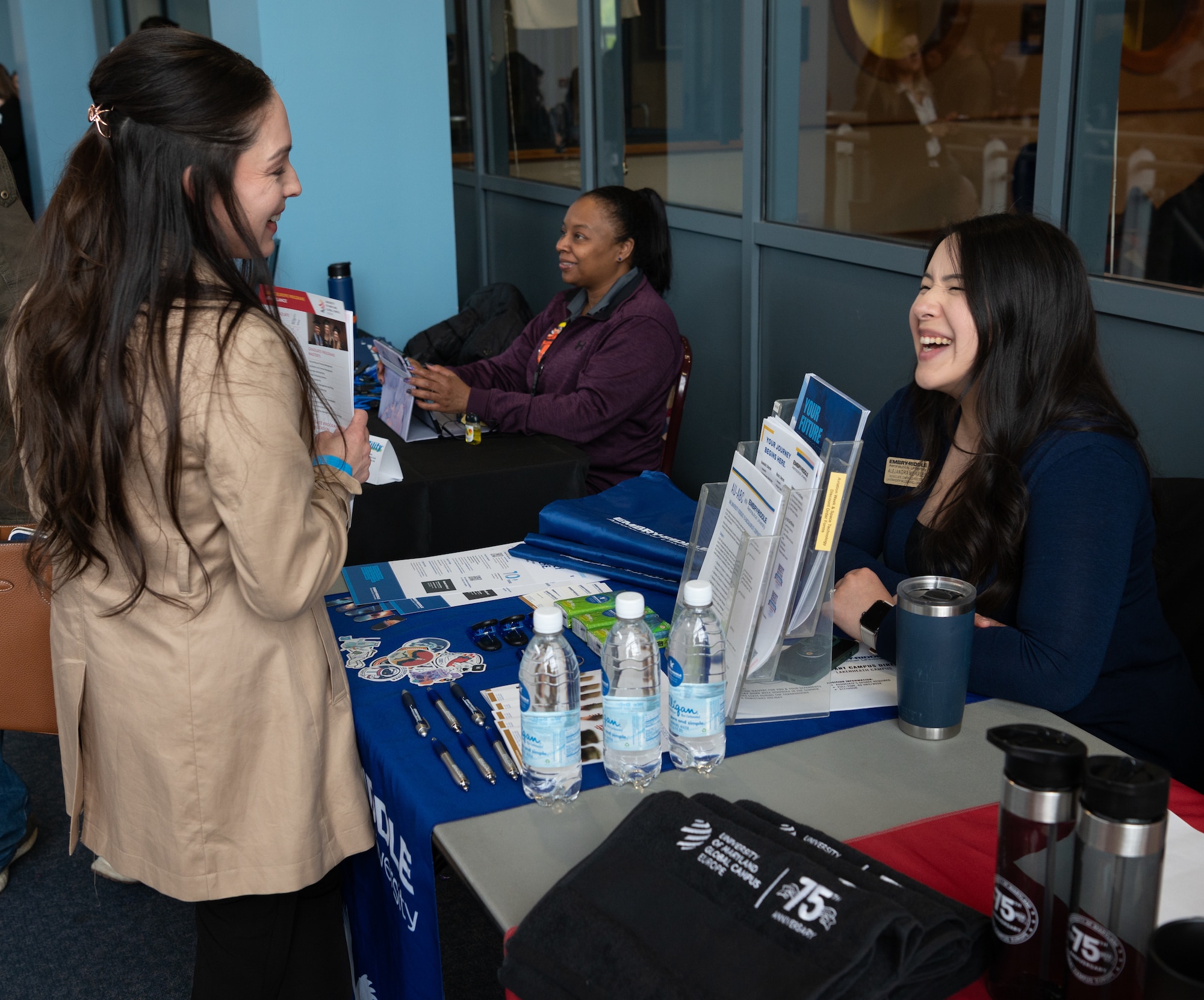Alejandra Morales, right, Embry-Riddle Aeronautical University associate campus director, speaks to an attendee during the Hiring Our Heroes career fair at Royal Air Force Mildenhall, England, April 22, 2024.