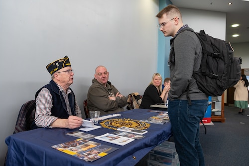 Darrell Russell, left, 48th Fighter Wing Retiree Activities Office director, speaks to U.S. Air Force Senior Airman Jaycie Gaedtke, UNIT tactical communications technician, during the Hiring Our Heroes career fair at Royal Air Force Mildenhall, England, April 22, 2024.