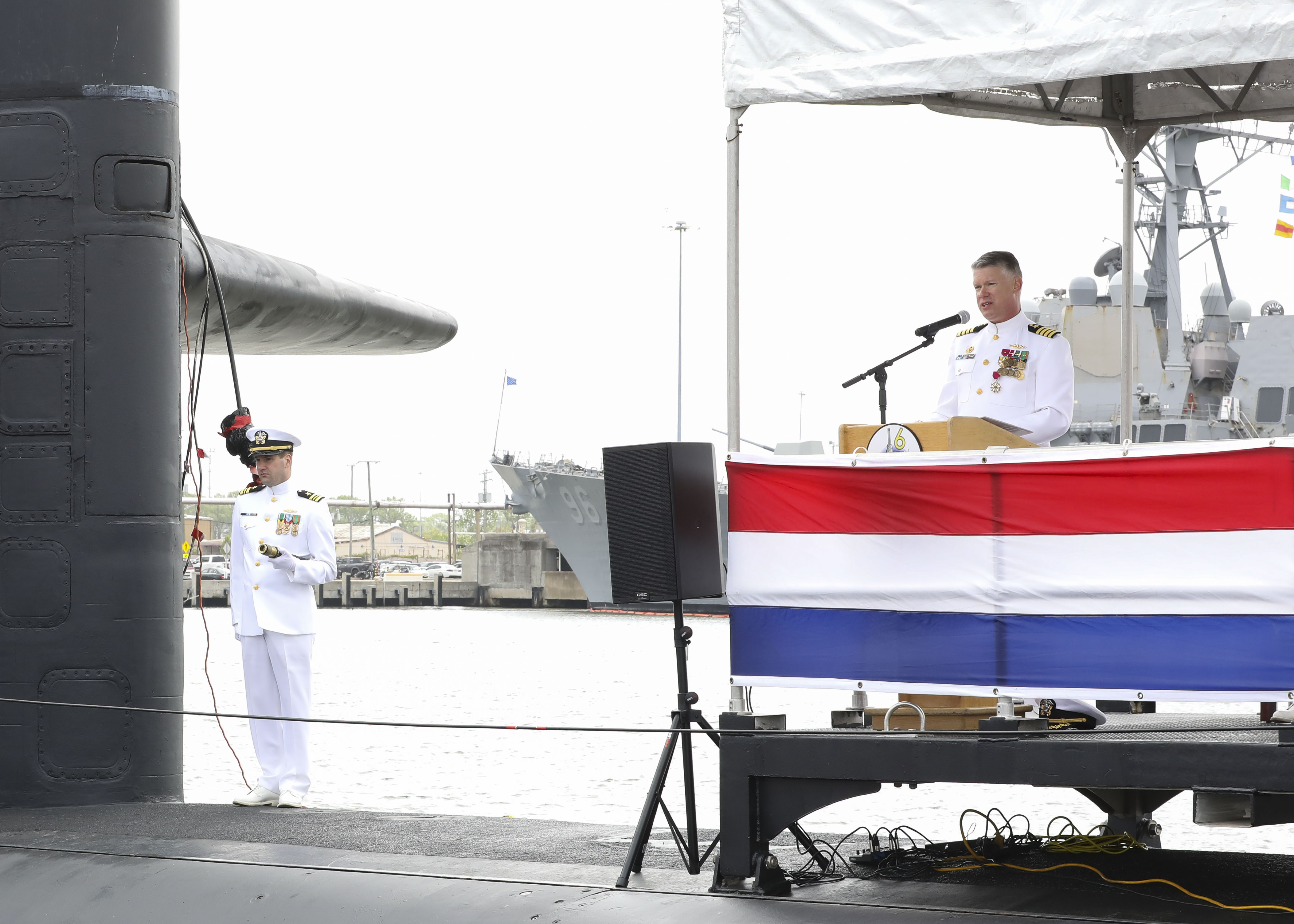 Capt. Jason Pittman, right, commodore, Submarine Squadron (CSS) SIX, delivers remarks during the Commander, Submarine Squadron (CSS) SIX change of command ceremony aboard the Los-Angeles class attack submarine USS Helena (SSN 725), April 25.