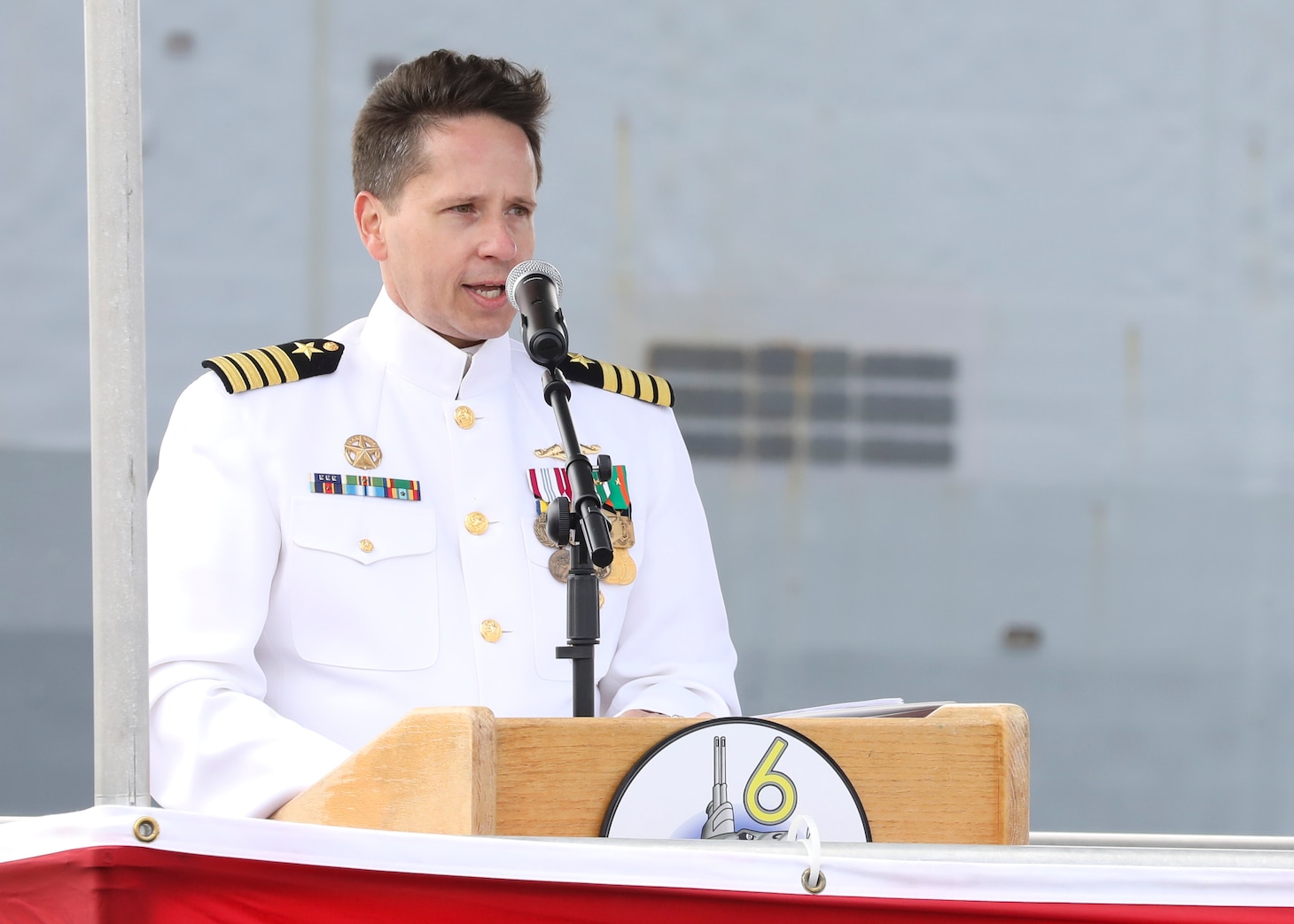 Capt. David Fassel, commodore, Submarine Squadron (CSS) SIX, delivers remarks during the Commander, Submarine Squadron (CSS) SIX change of command ceremony aboard the Los-Angeles class attack submarine USS Helena (SSN 725), April 25.