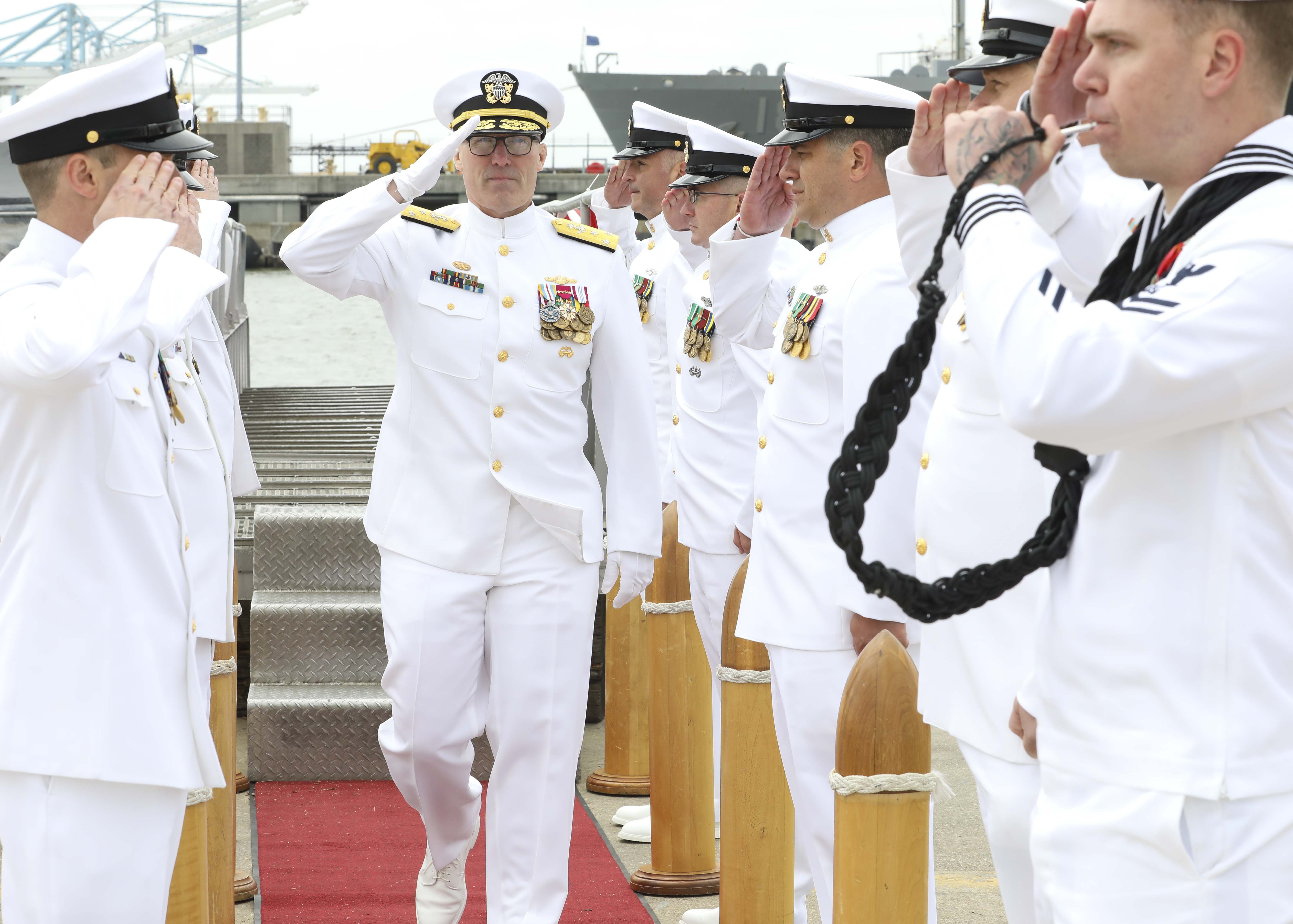 Vice Adm. Rob Gaucher, commander, Submarine Forces, renders a salute to sideboys during the Commander, Submarine Squadron (CSS) SIX change of command ceremony, April 25.